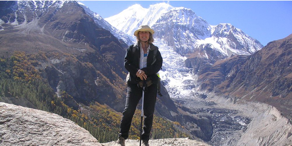 Adventure Girl with Ganga Purna Glacier in Manang Valley.